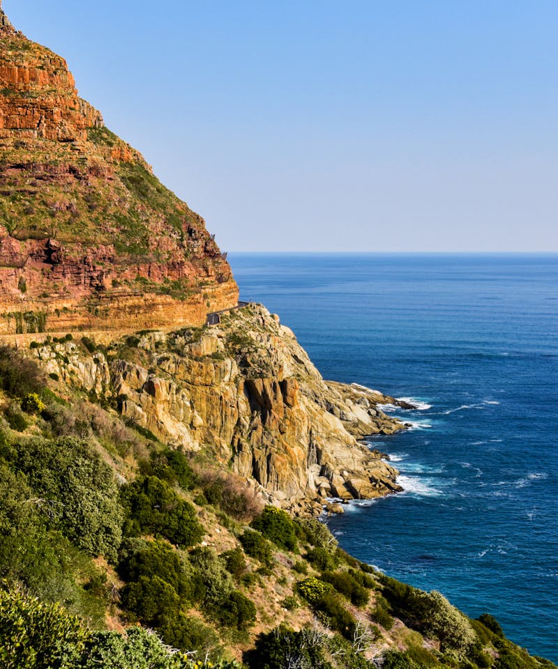 Beautiful coastal cliffs and ocean view in South Africa, showcasing nature's vibrant hues.