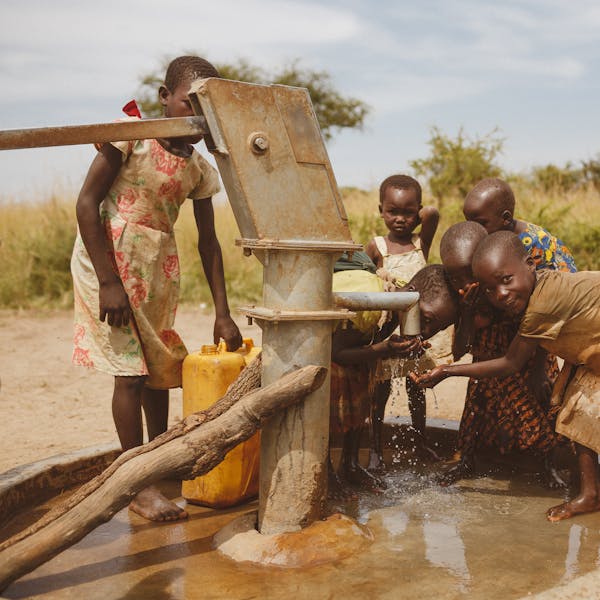 Group of children gathering water from a well in Kitgum, Uganda.